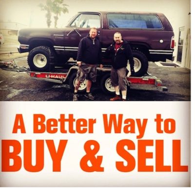 Two men standing next to a truck with the words " a better way to buy & sell ".