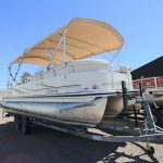 A boat is parked on the dock with a cover.