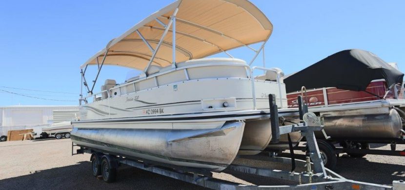 A boat is parked on the dock with a cover.