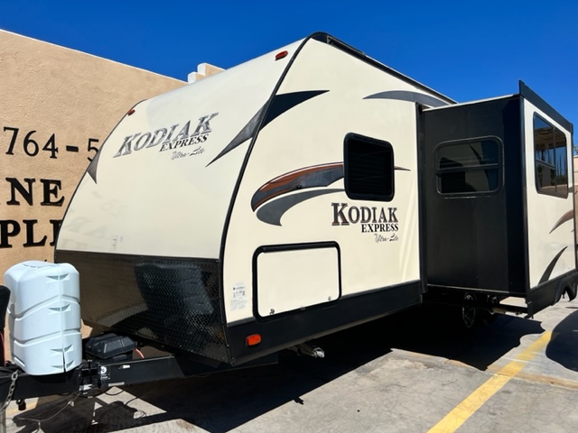 A white and black trailer parked in the parking lot.