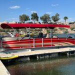 A red boat is docked at the dock.