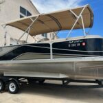 A boat is parked in the street under an awning.