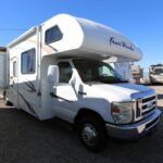 A white rv parked in the parking lot.