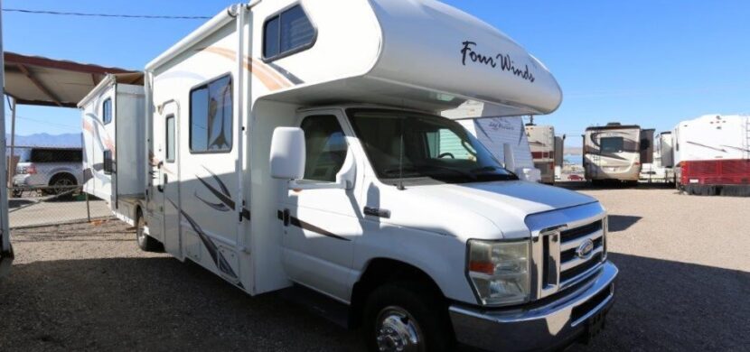 A white rv parked in the parking lot.