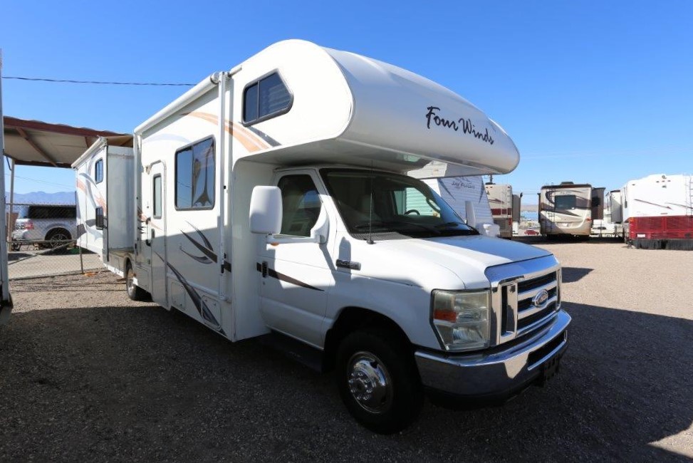 A white rv parked in the parking lot.