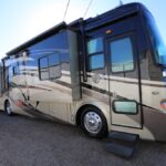 A large rv parked on the side of a road.