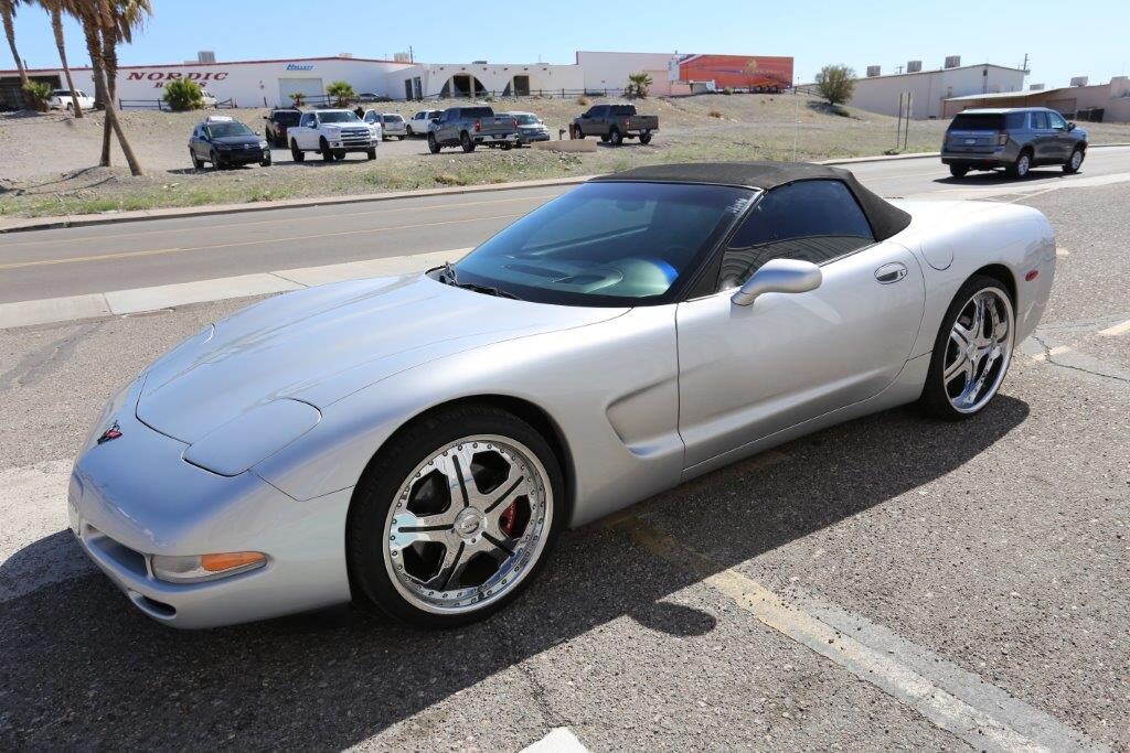 A silver sports car parked in the parking lot.