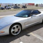 A silver sports car parked in the parking lot.