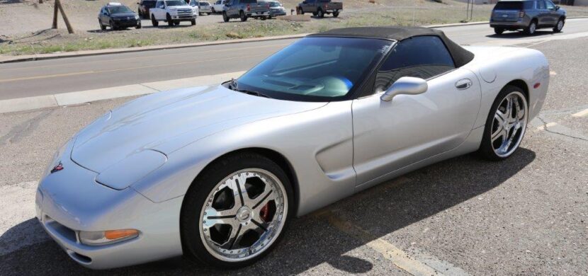 A silver sports car parked in the parking lot.