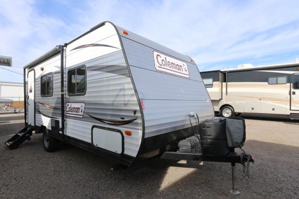 A white camper trailer parked in the parking lot.