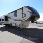 A large rv parked on the side of a road.