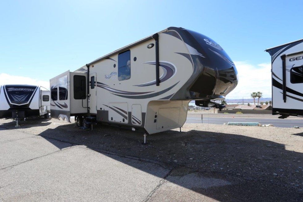 A large rv parked on the side of a road.