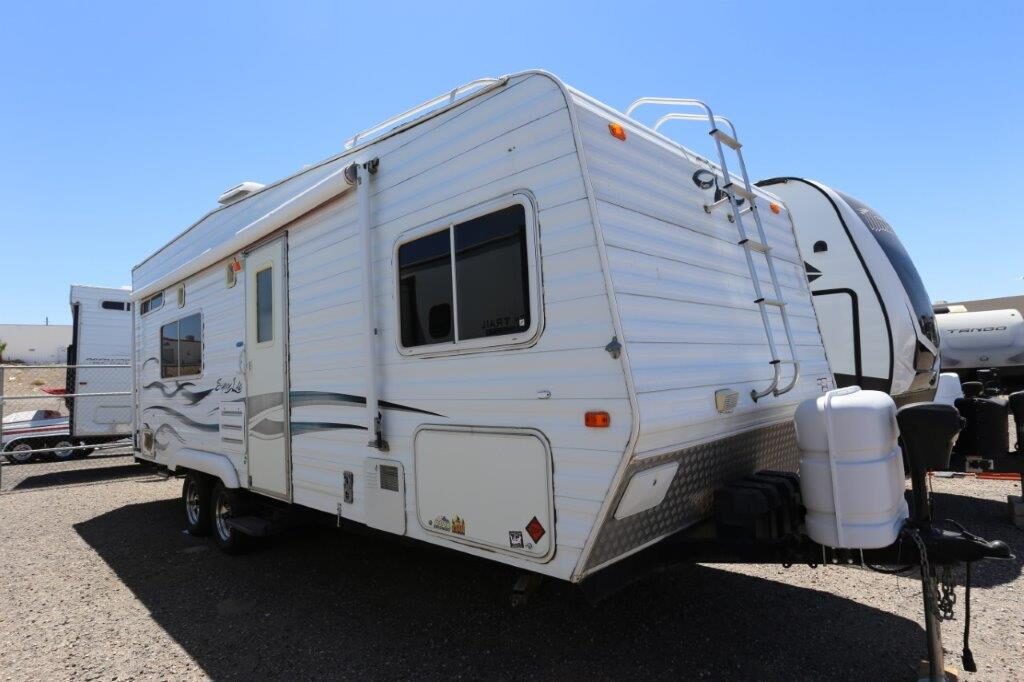 A white rv parked in the middle of nowhere.