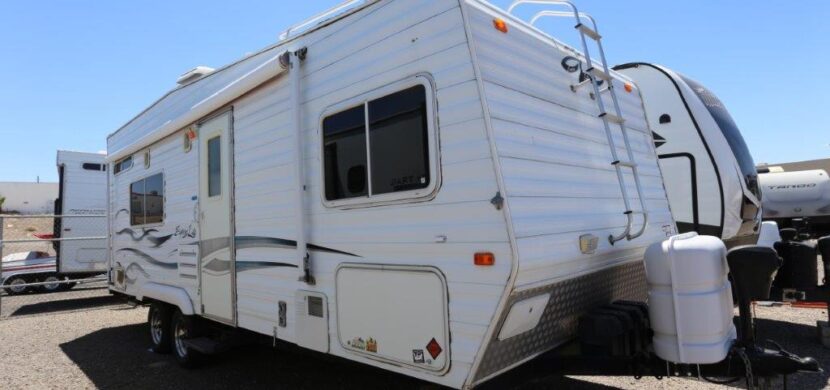 A white rv parked in the middle of nowhere.