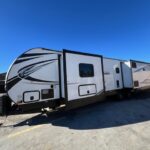 A white and black trailer parked in the parking lot.