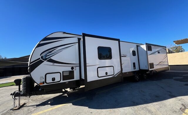 A white and black trailer parked in the parking lot.