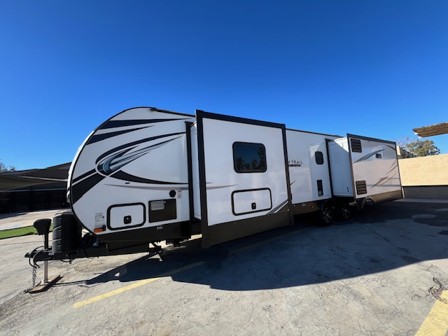 A white and black trailer parked in the parking lot.